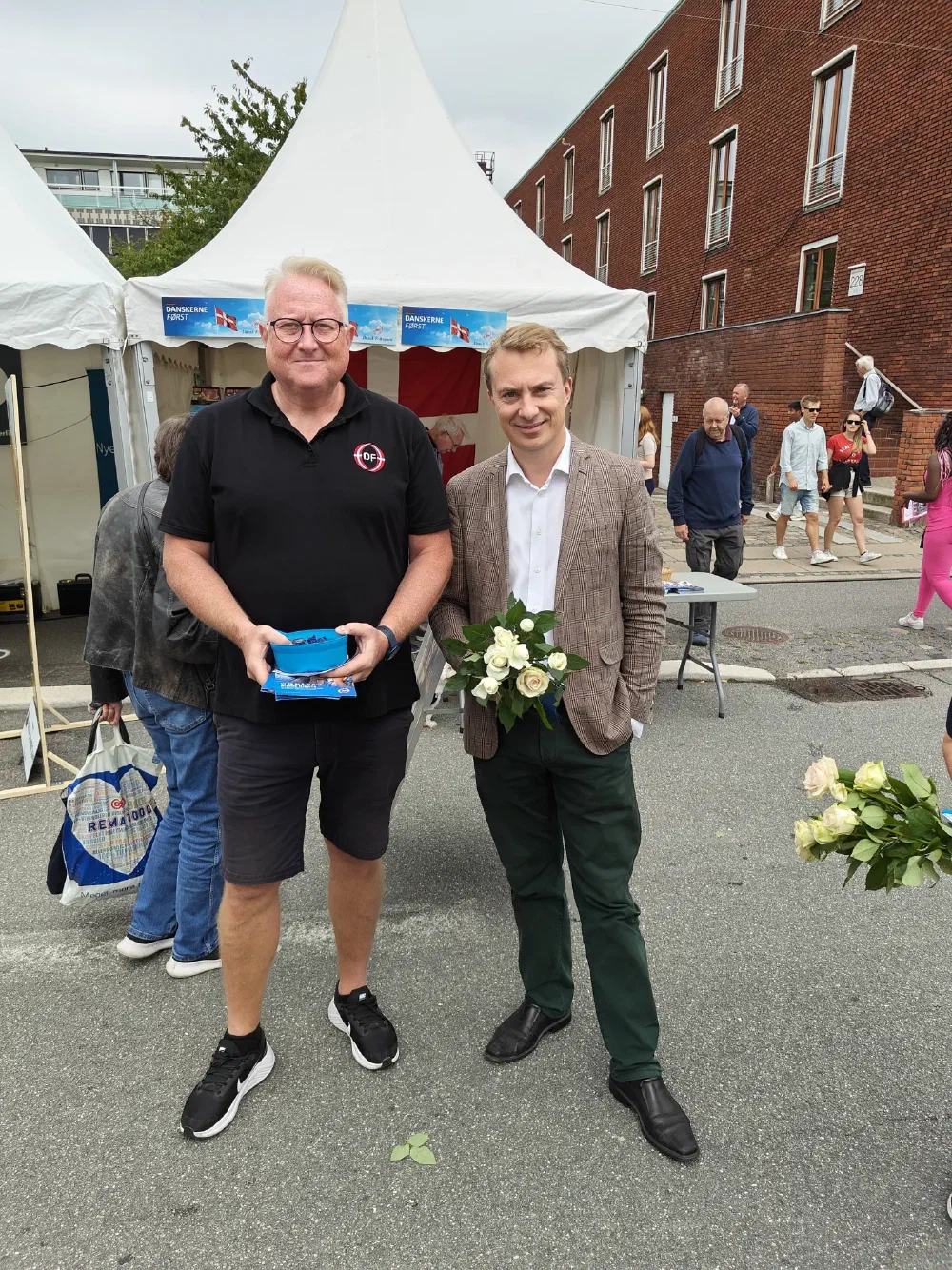 Kristian Tørning ved DF-teltet sammen med en gæst i ternet jakke med roser